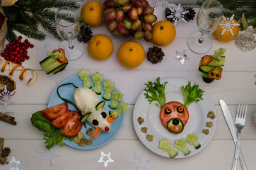 Edible rat and edible deer made of vegetables for the festive New Year and Christmas table. Idea for decorating holiday dishes. How nice to serve vegetables and salad.