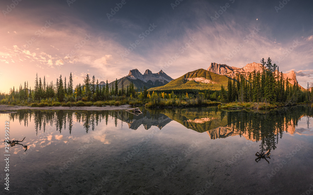 Panorama of Three sisters mountain reflection on pond at sunrise in autumn at Banff national park - obrazy, fototapety, plakaty 
