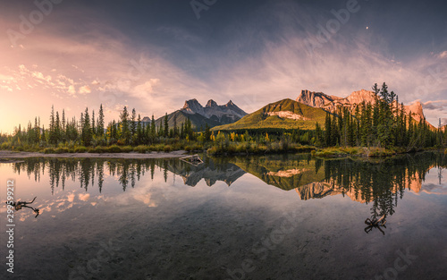 Cuadros en Lienzo Panorama of Three sisters mountain reflection on pond at sunrise in autumn at Ba