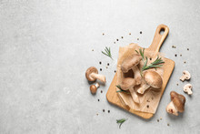 Flat Lay Composition With Fresh Wild Mushrooms On Light Grey Table, Space For Text