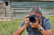 © jovannig - Male photographer making pictures of outdoor countryside scenario