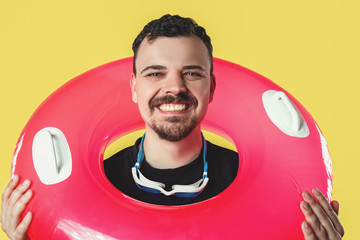 smiling guy with a swimming circle