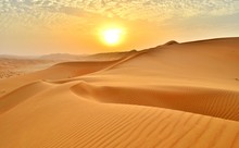Sunset At The Edge Of The Rolling Sand Dunes In The Empty Quarter (Desert) Outside Abu Dhabi, United Arab Emirates