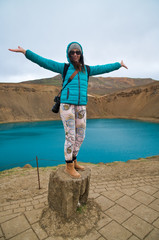 Wall Mural - Happy woman embracing Krafla crater and lake in Nothern Iceland