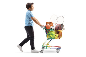 Sticker - Boy walking and pushing a mini cart with sport items