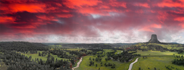 Panoramic aerial view of Devils Tower National Monument at summer sunset, Wyoming from drone perspective