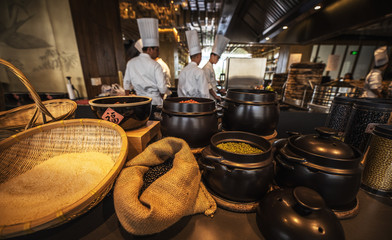 Wall Mural - Traditional preparing food and professional Chinese cooks at kitchen.