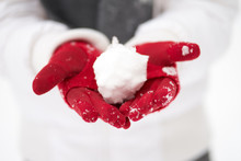 Girl's Hands In Red Gloves Making Snowball