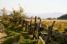 Old Rural Wooden Fence On A Background Of Mountains In The Distance
