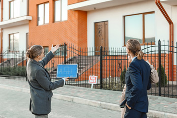 Sticker - Real estate agent showing young couple a new house outdoors