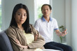 © Pormezz - Asian couple having relation problem. Wife crying and sitting separate with her husband at home after quarrel.