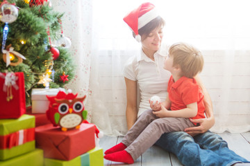 Wall Mural - Mother with her son decorating Christmas tree together, farm house design