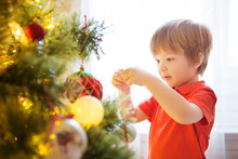 Xmas Party Celebration. Child Decorating Christmas Tree At Home. Family With Kids Celebrate Winter Holidays. New Year Small Boy At Decoration Toy