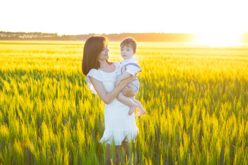 Sticker - Happy family, mother and little son boy in the meadow