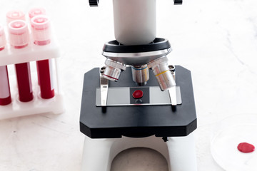 Blood drop under microscope on white background