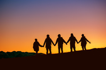 Wall Mural - silhouettes group of friends together at sunset