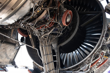 Wall Mural - Gas turbine engine close up during maintenance when airplane park at the airport.Mechanic and technician repair hydraulic and check system of power plant.