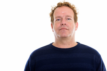 Studio shot of mature man with curly blond hair isolated against white background