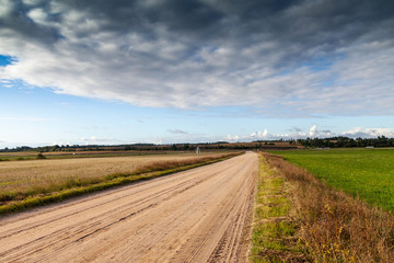 Wall Mural - Gravel road in countryside landscape.