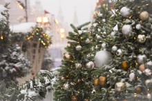 Closeup Of A Christmas Tree With Ornaments And Covered In Snow
