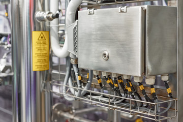 Electrical cabinet made of stainless steel. The cabinet box includes many black cables