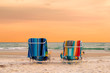 © lucky-photo - Sunset view of lounge beach chairs with towels in Siesta Key Beach of Florida Gulf Coast, USA