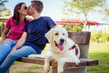 Romantic happy couple in love enjoying their time with pets in nature