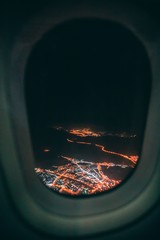 Sticker - Vertical shot of a city at night taken from an airplane window