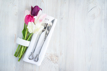 Wall Mural - Festive background. Place setting with fresh tulips