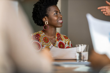 beautiful young confident professional black african business woman smiling in meeting