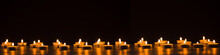 Burning Golden Candles On Black Background. Mourning, Grief, Mourning Or Christmas Concept.