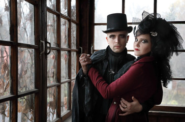 Portrait a young couple wearing vampire-style clothes