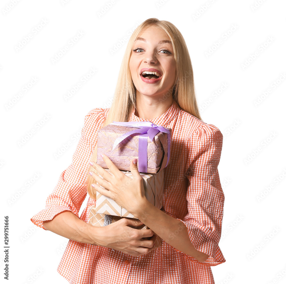 Beautiful young woman with gifts on white background