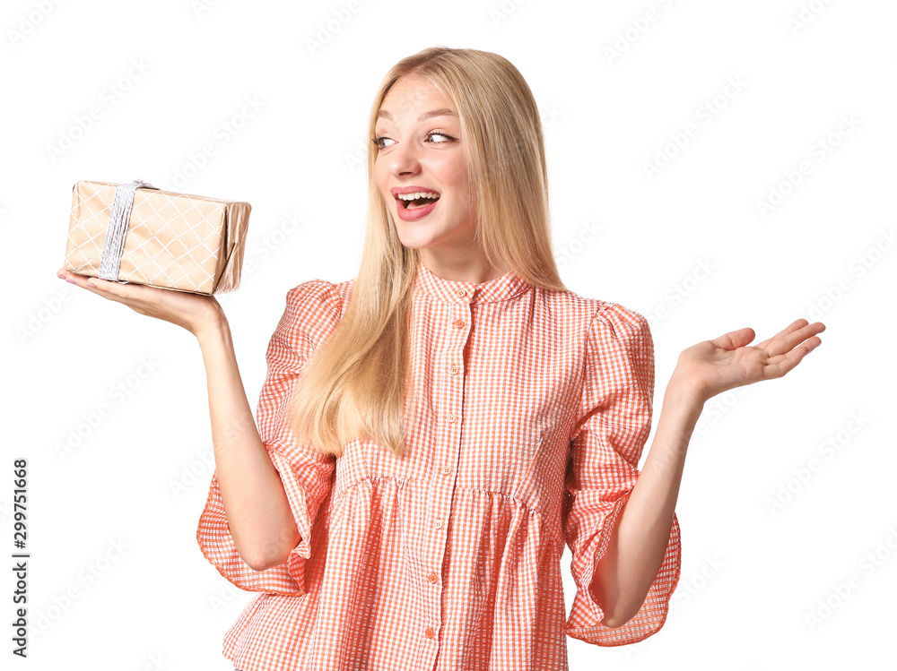 Beautiful young woman with gift on white background