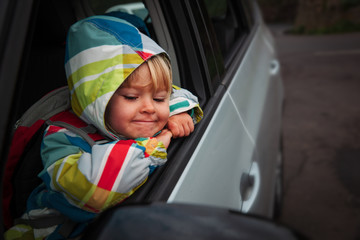 happy little girl travel by car on road