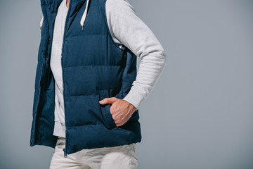 cropped view of man posing in autumn waistcoat, isolated on grey