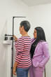 © ClicksdeMexico - DOCTOR DIETIST WEIGHTING WOMAN SMILING SICK IN SCALE FOR WEIGHT CONTROL AND CARDIAC REVIEW WITH STETHOSCOPE ROUTINE HEALTH REVIEW FOR MEDICAL CARE