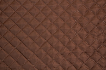  Quilted fabric. The texture of the blanket.	