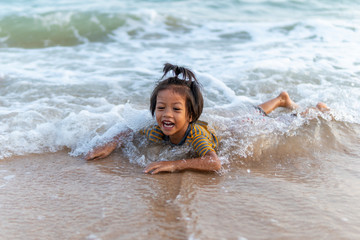 Little girl are playing in the sea together with fun.