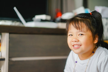 Wall Mural - Happy Little asian girl child showing front teeth with big smile and laughing: Healthy happy funny smiling face young adorable lovely female kid.Joyful portrait of asian elementary school student.