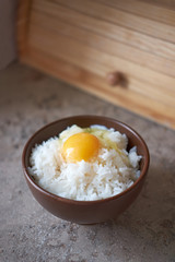 Wall Mural - Tamago kake gohan with raw egg in bowl, vertical orientation