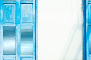 Close up Window and white wall in Oia town on Santorini island, Greece. Traditional and famous houses and churches with blue domes over the Caldera, Aegean sea  M