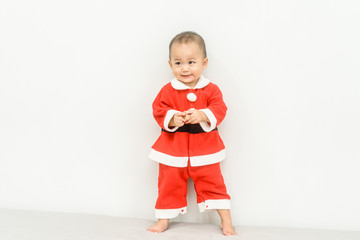 Wall Mural - Little baby boy child in Santa suit, laughing and smiling.Baby in red Christmas costume isolated on white background.