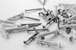 © malshak_off - A small number of screw anchors that are scattered on a white background. Plastic plugs with screws for repair.