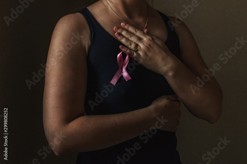 October is breast cancer awareness month,a woman holds a pink ribbon to support people living and sick.Health, international women\'s day and the concept of the world day of fight against cancer.Noises