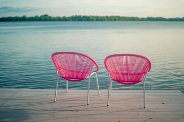 2 pink chairs on the beach