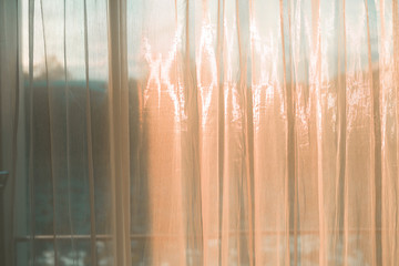 Wall Mural - orange light of  sun and curtains in the bedroom 