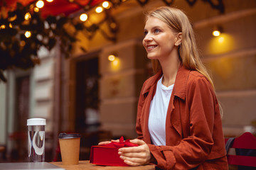 Canvas Print - Happy girl waiting for someone in a cafe