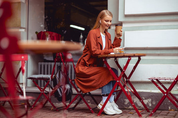 Wall Mural - Good-looking girl with a cup of coffee outdoors