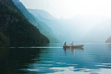 Loving Young Couple In Boat At Lake. Date Walk Man And Woman In Alpine Mountains